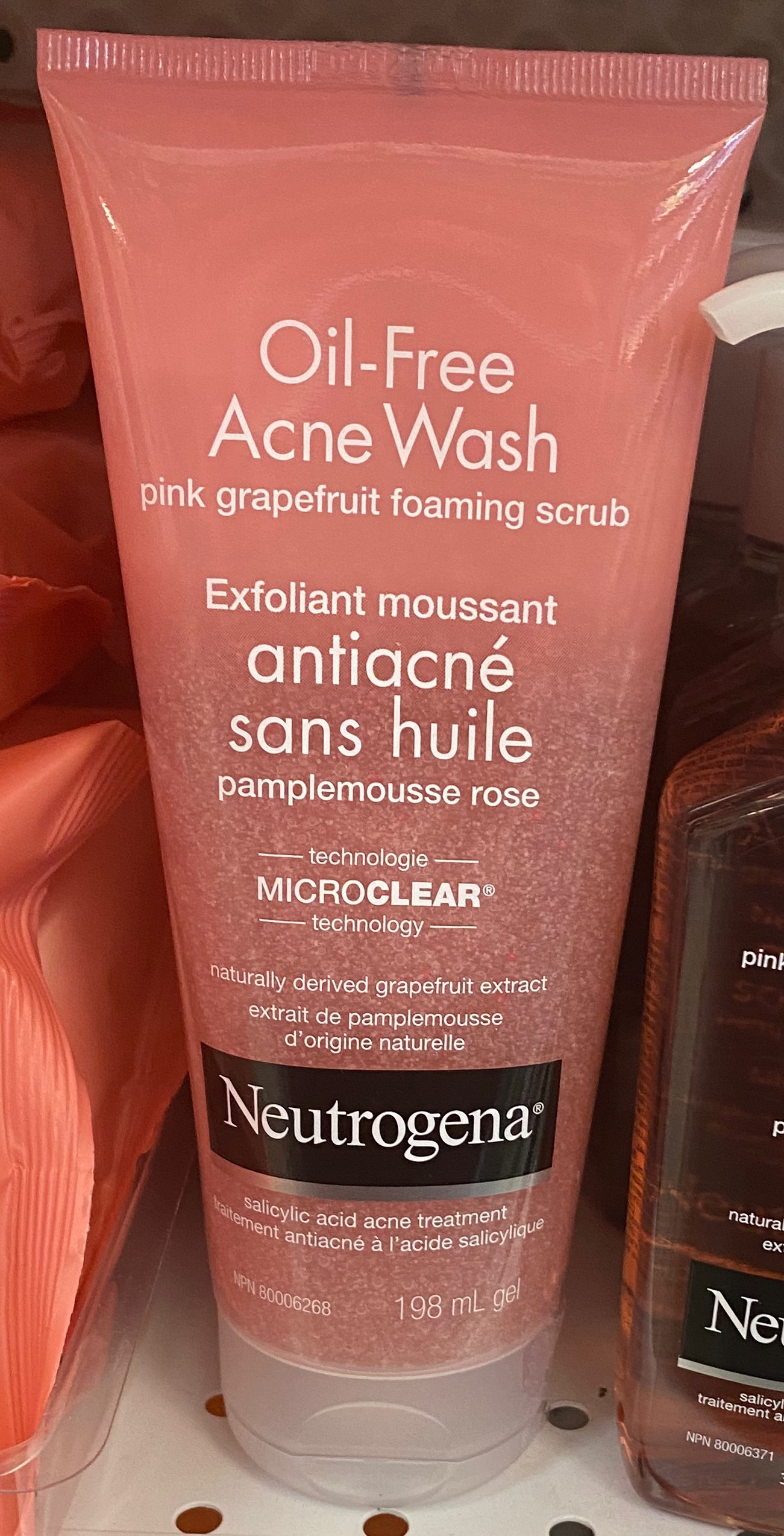 Pink acne-wash tube with salicylic acid acne treatment wording on its front