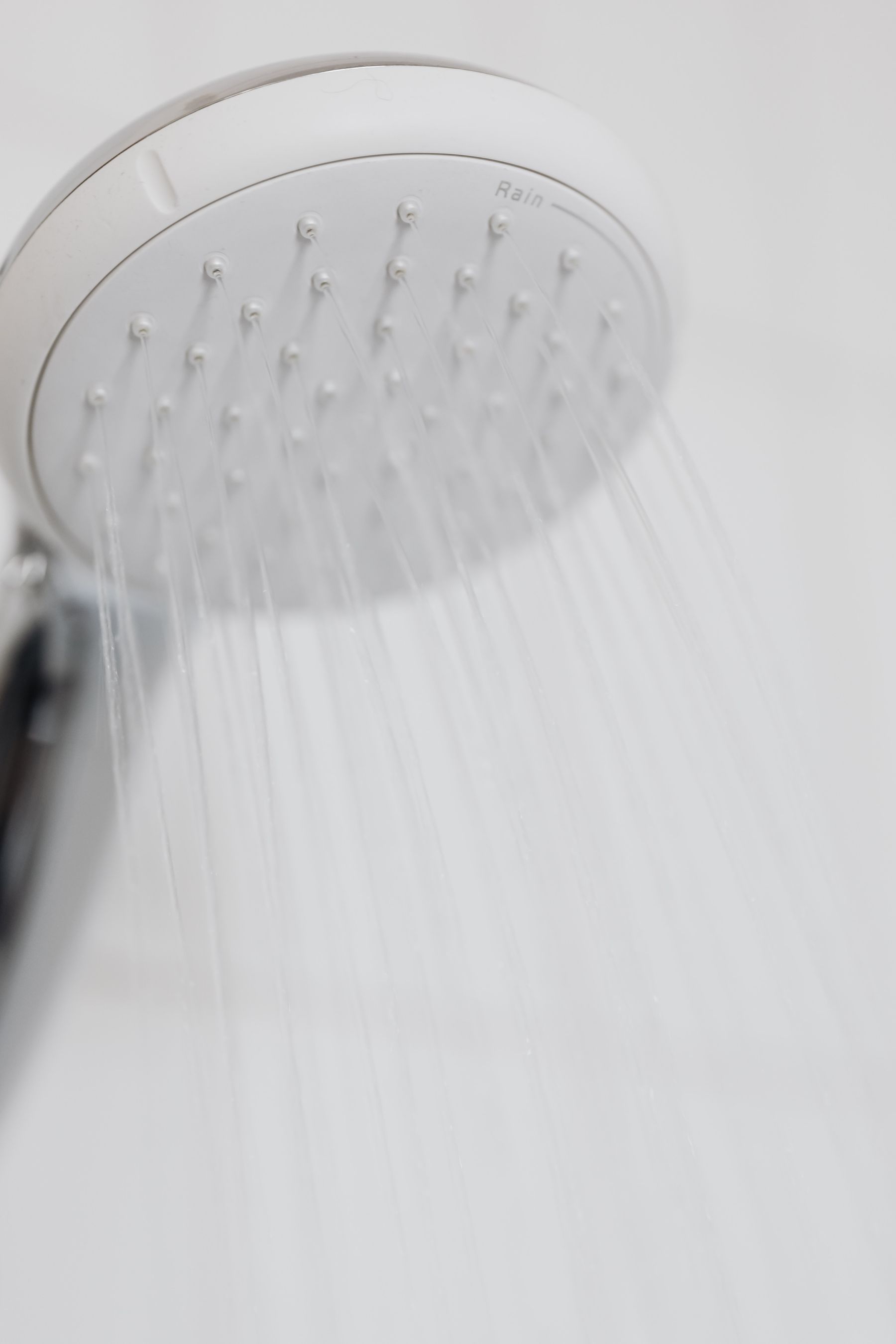 Close view of water spraying from a round showerhead