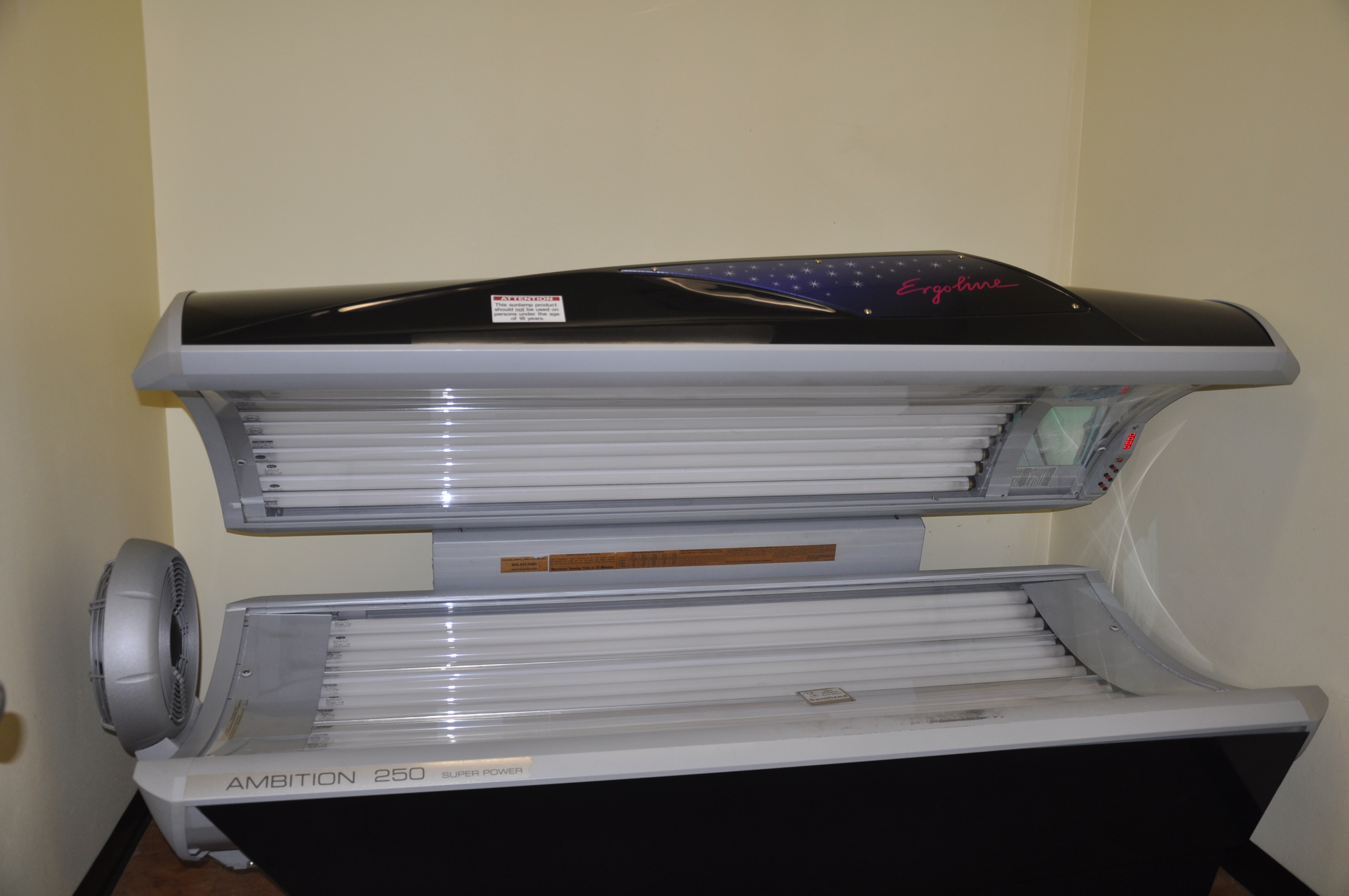 An open indoor tanning bed with rows of lamps